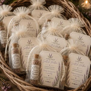 May include: A collection of small glass vials filled with tiny brown particles, each sealed with a cork stopper and tucked into a sheer cream organza drawstring bag. Each bag includes a rectangular card labeled A little vial of Scottish Heather.