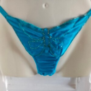 May include: Turquoise blue lace underwear with a gold butterfly design.