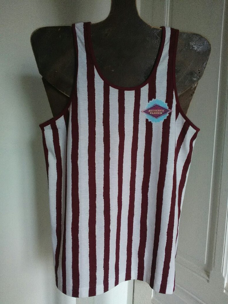 May include: White and burgundy striped tank top with a small blue and white logo that says "Authentic Fashion".
