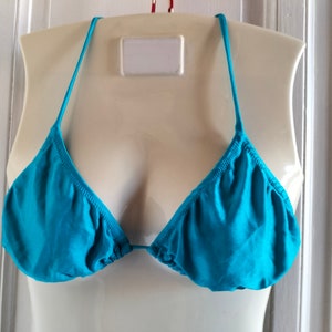 May include: A turquoise bikini top with adjustable straps.