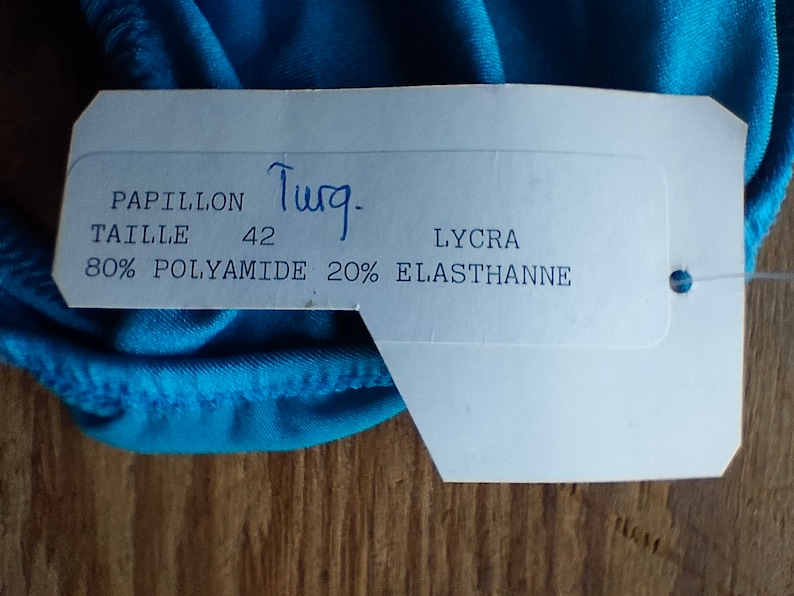 May include: White tag with blue writing, "Papillon", "Taille 42", "80% Polyamide 20% Elasthanne", "Lycra".