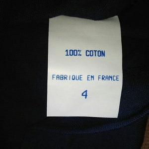 May include: White tag with blue text that reads "100% COTON FABRIQUE EN FRANCE 4".