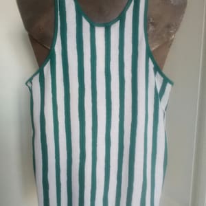 May include: A white tank top with green vertical stripes. The tank top is sleeveless and has a scoop neck.