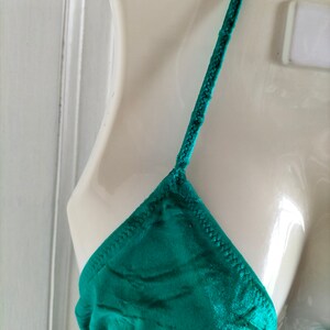 May include: A teal green satin triangle bikini top with adjustable straps.