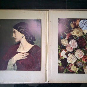 May include: Two framed paintings, one depicting a woman in a burgundy dress with her hand on her chest, and the other depicting a bouquet of pink, white, and red roses.