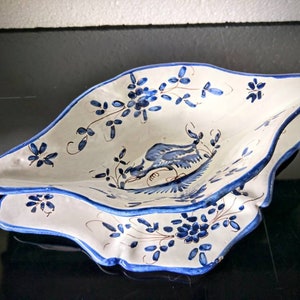 Vintage faience glazed pottery gravy boat. The bowl is attached to the dish. Blue White Phoenix flower decoration.