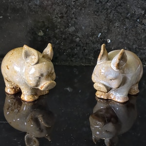 Two vintage pottery ceramic glazed pig figurines.