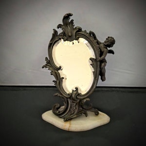 Antique bronzed metal standing mirror with cherub. Art nouveau.