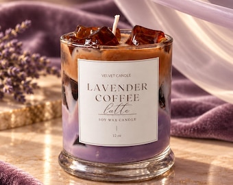 May include: A clear glass candle with a white label reading VELVET CANDLE LAVENDER COFFEE latte SOY WAX CANDLE 12 oz. The candle features layers of purple and brown wax topped with dark brown wax cubes resembling ice and a single white wick.