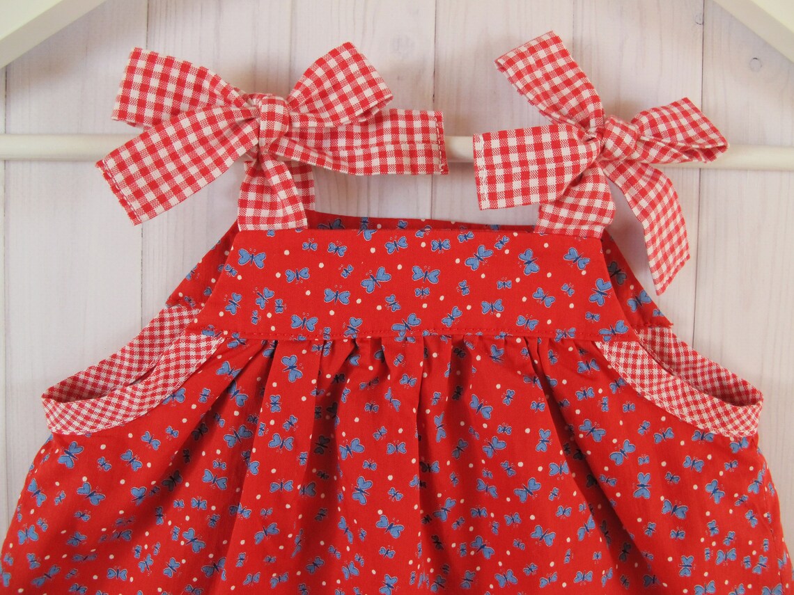 red newborn gown