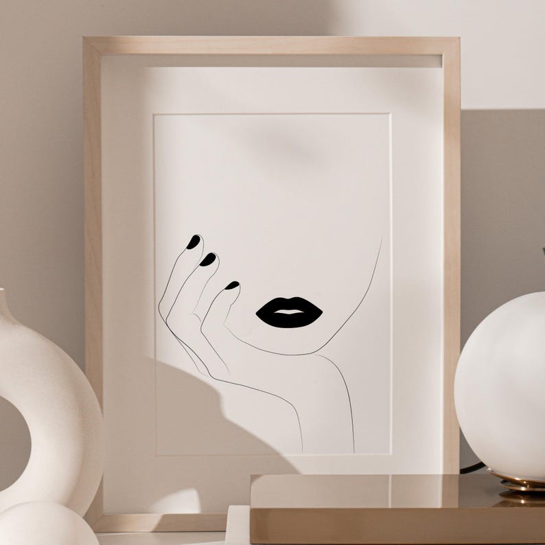 May include: A black and white line drawing of a woman's face with black lipstick and nails. The woman's hand is resting on her chin.