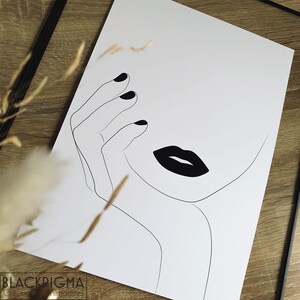 May include: Line art drawing of a woman's face with black lips and a hand resting on her cheek. The drawing is in black and white on a white background.
