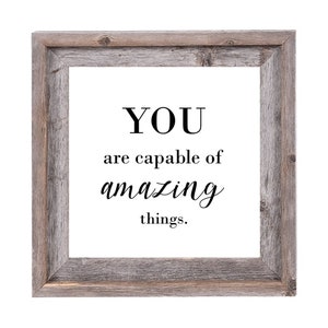 May include: A framed inspirational quote in a rustic wood frame. The quote reads "YOU are capable of amazing things."