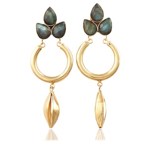 May include: Gold hoop earrings with a teardrop-shaped pendant and three dark blue gemstone accents.
