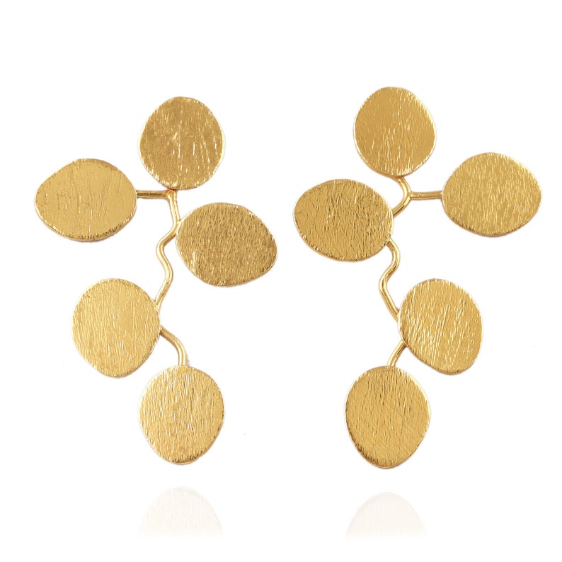 May include: A pair of gold earrings with a leaf design. Each earring has seven small, round, textured gold leaves connected by thin gold wires.