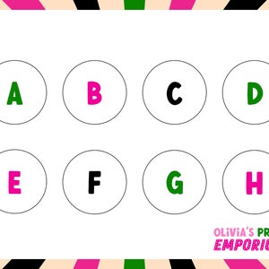 May include: A white sheet with eight circles, each containing a letter of the alphabet from A to H. The letters are in different colors: pink, black, and green. The text "OLIVIA'S PRINT EMPORIUM" is at the bottom of the sheet.