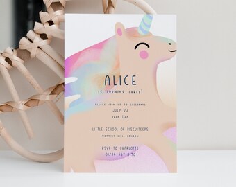 May include: A pastel pink and blue unicorn illustration with a rainbow background. The text reads "Alice is turning three!"  "Please join us to celebrate July 23 from 11am"  "Little School of Biscuitters Notting Hill, London"  "RSVP to Charlotte 01224 567 8190"