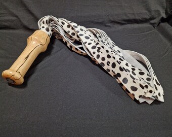 Edgyyyyy Designs hair-on cow spot leather flogger with spalted beech handle.