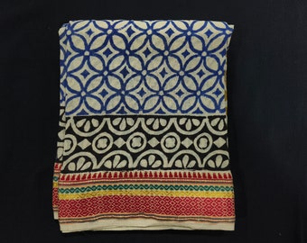 May include: A white cotton fabric with a blue and white geometric pattern, a black and white geometric pattern, and a red, green, and gold border.