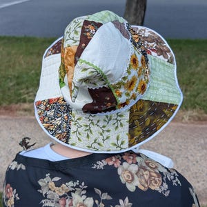 Slouchy Patchwork Hat shown from back being worn sitting on bench.