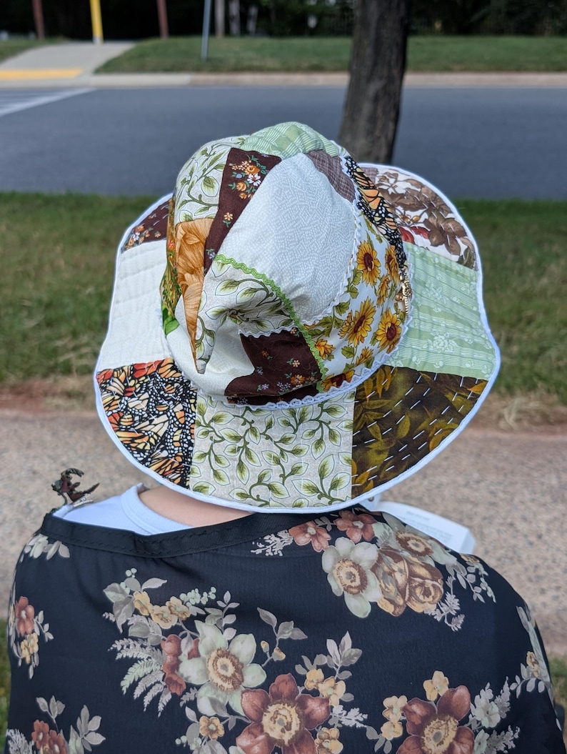 Slouchy Patchwork Hat shown from back being worn sitting on bench.