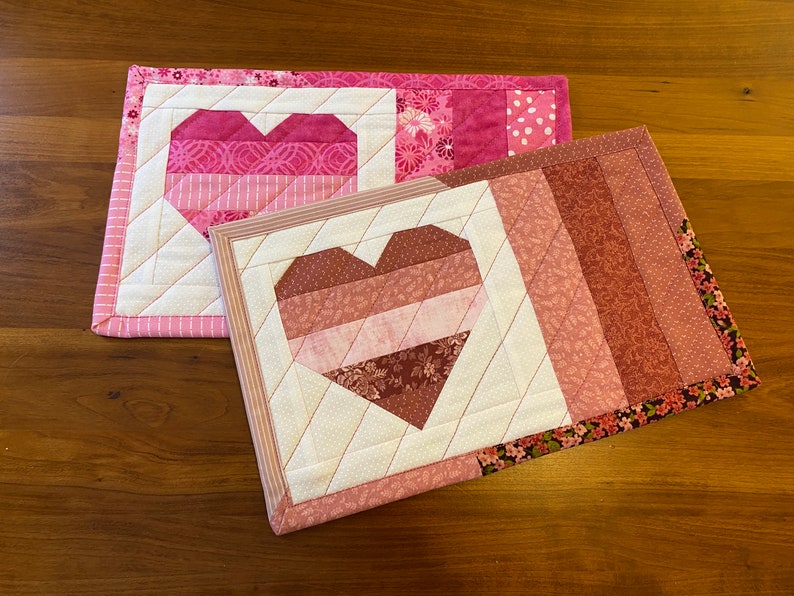 Two finished heart mug rugs