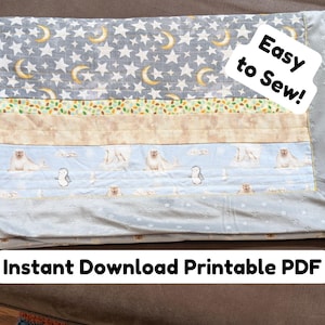 May include: A patchwork quilt with various patterned fabrics. The top section features a gray background with white stars and yellow crescent moons. Other sections include a leaf pattern, a tan fabric, and a light blue fabric with seals and penguins. Text reads "Easy to Sew!" and "Instant Download Printable PDF."