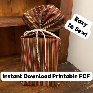 May include: A wrapped gift with a striped pattern in red, green, and gold, tied with white string. The top is gathered and tied. Text on the image reads "Easy to Sew!" and "Instant Download Printable PDF".