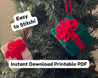 May include: Two square ornaments made of stitched yarn, one white and one dark green, each featuring a bright red yarn bow and a red vertical stripe. The text "Easy to Stitch!" and "Instant Download Printable PDF" is visible on the image.