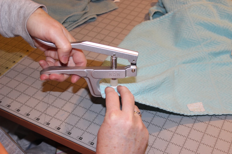 Step photo from tutorial, showing kam snap pliers.