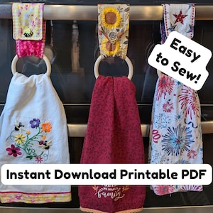 May include: Three hanging kitchen towels with wooden rings and fabric toppers. The left towel is white with floral embroidery, the center is maroon with text, and the right has a firework pattern. Text reads Easy to Sew! Instant Download Printable PDF.