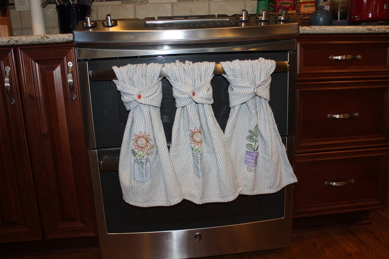 Herb towels with Kam snaps hanging on stove handle.