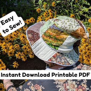 May include: A patchwork bucket hat with various floral and patterned fabrics. The hat has a white quilted brim and is labeled "Easy to Sew!" and "Instant Download Printable PDF". The background features yellow flowers.