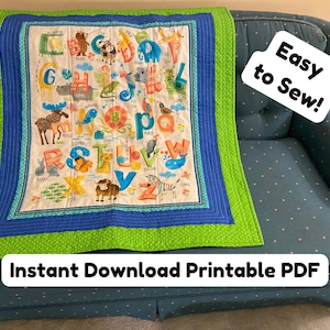 May include: A colorful alphabet quilt with animal illustrations, featuring a green border, blue accents, and the text "Easy to Sew!" and "Instant Download Printable PDF". The quilt is displayed on a blue sofa.