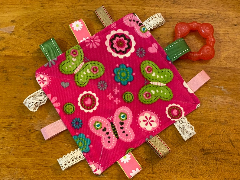 Finished tag toy showing sewn X across the center.