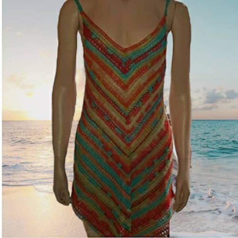May include: A colorful crochet dress with a chevron pattern in shades of orange, red, green, and blue. The dress is sleeveless and has a V-neckline.