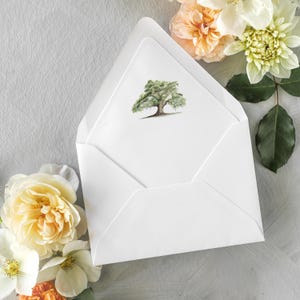 May include: A white envelope with a simple design featuring a watercolor illustration of a green tree on the front.