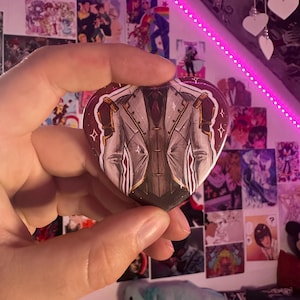 Jayce Talis chest heart pin