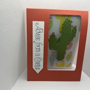 May include: A red card with a window showing a white background with a green cactus and the text "Advice from a Cactus" on a white tag.