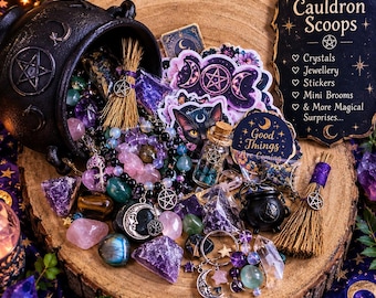 May include: A black cast iron cauldron overflowing with assorted crystals, gemstone bracelets, mini brooms, and stickers. A sign reads Cauldron Scoops with a list of items including crystals, jewellery, stickers, and mini brooms. The items feature pentagram and moon motifs.