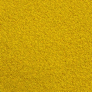 May include: A close-up image of a surface covered in small, bright yellow round sprinkles.