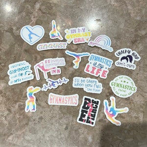 May include: A selection of gymnastics-themed stickers with diverse designs and text. The stickers showcase colourful illustrations of gymnasts in action, alongside phrases such as "Gymnast," "Gymnastics is my life," and "In my gymnast era."