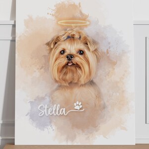 May include: Canvas gallery wrap featuring a portrait of a Yorkshire Terrier with a halo. The dog has light brown fur and a small pink tongue. The name "Stella" and a paw print are below the dog. The background has watercolor-style splashes.