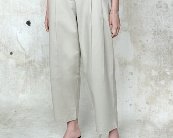 Beige cotton high waisted trousers, with double pleat to front and patch pockets to rear