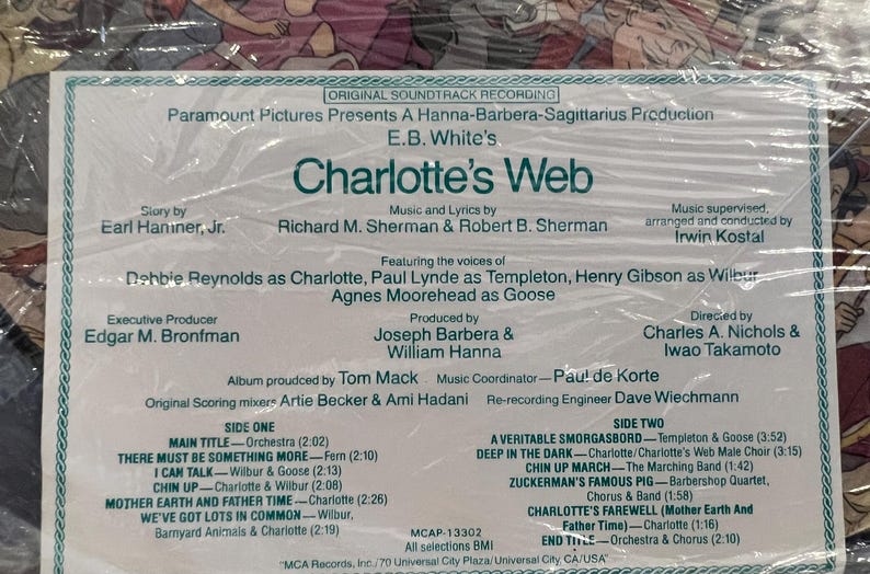 May include: A vintage record album cover for the soundtrack to the movie Charlotte's Web. The cover features a green and white design with the title of the movie in large, bold letters. The album features the voices of Debbie Reynolds, Paul Lynde, Henry Gibson, and Agnes Moorehead. The album was produced by Joseph Barbera and William Hanna and directed by Charles A. Nichols and Iwao Takamoto.