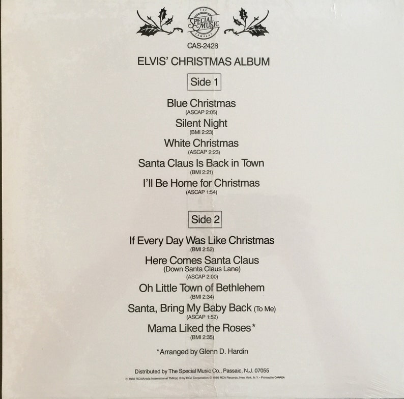 May include: A white vinyl record album cover for Elvis' Christmas Album. The cover features the album title, "Elvis' Christmas Album", and a list of songs on each side of the record. The album is from the Special Music label and has the catalogue number CAS-2428.