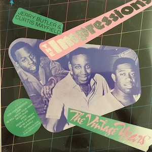 May include: A vintage vinyl record album cover featuring a photo of The Impressions, a popular soul music group. The cover is black with a green and pink design. The album title is "The Impressions: The Vintage Years". The album features Jerry Butler and Curtis Mayfield.