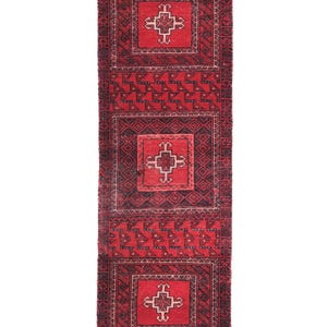 May include: A rectangular red and black rug with a repeating geometric pattern. The rug features three square medallions with a central cross design, surrounded by intricate borders and geometric shapes. The rug's dimensions are not visible.