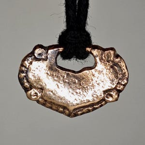Small ancient Viking amulet with a heart. An ancient amulet. Antique Viking Age pendant. An ancient gift from the Vikings. Viking Valentine