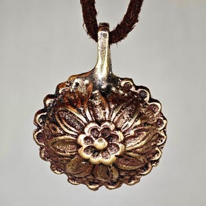 Medieval amulet in the form of a flower. Medieval artifacts. Medieval pendant. Medieval amulet. Medieval jewelry. Medieval pendant.